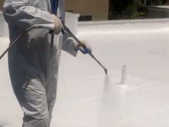 DC Roofing spraying on commercial roof coating in Tucson